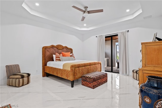 bedroom featuring access to exterior, a raised ceiling, and ceiling fan