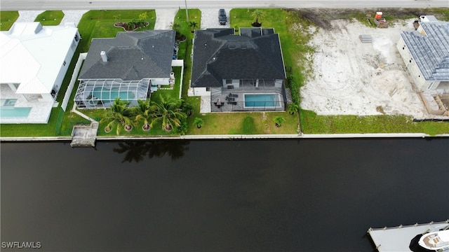 birds eye view of property with a water view