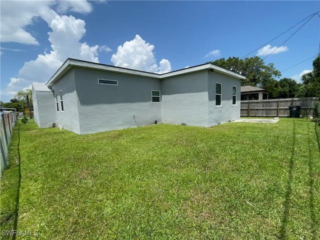 back of house with a lawn