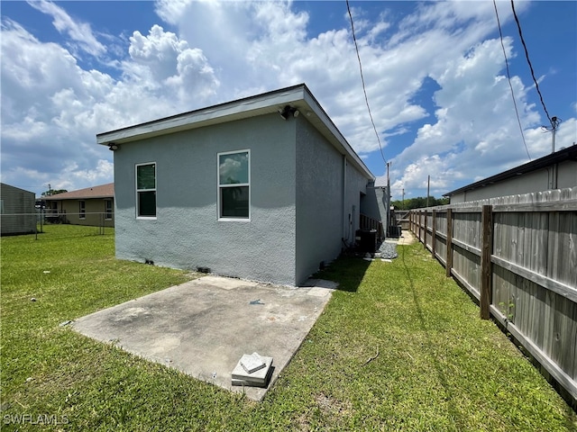 back of property with a patio and a yard