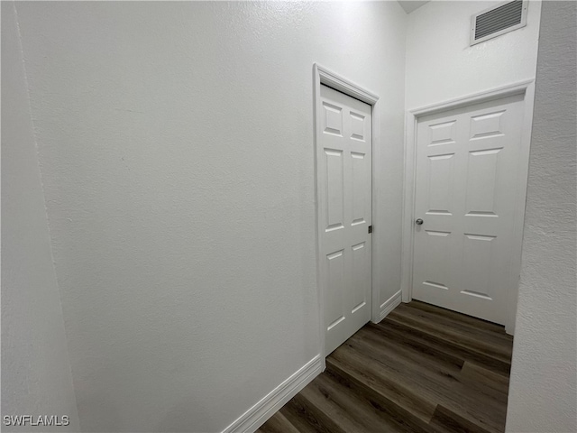 corridor with dark hardwood / wood-style floors