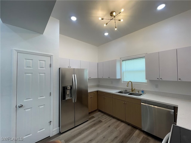 kitchen with light wood-type flooring, sink, and stainless steel appliances