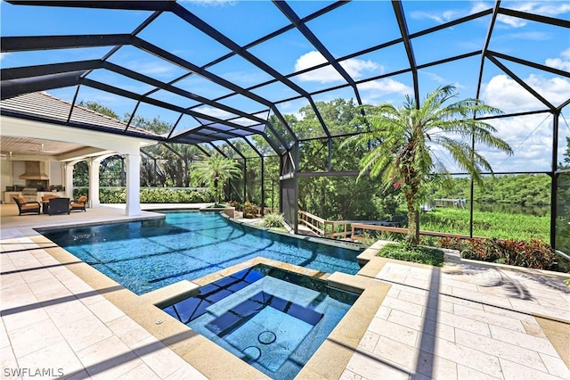 view of pool featuring an in ground hot tub, outdoor lounge area, a patio, and glass enclosure