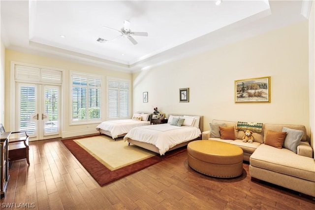 bedroom with crown molding, access to outside, a tray ceiling, ceiling fan, and hardwood / wood-style floors