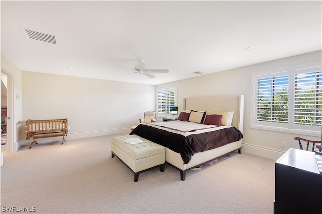 bedroom featuring light carpet and ceiling fan