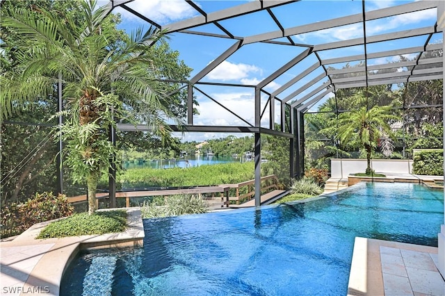 view of pool with a water view, a patio, and glass enclosure