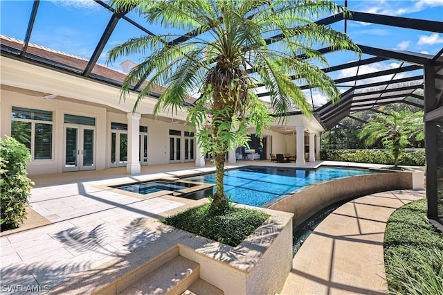 view of swimming pool featuring an in ground hot tub, glass enclosure, a patio, and french doors