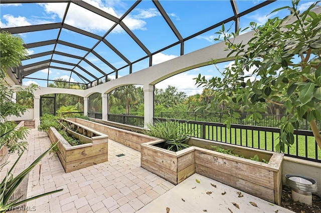 view of patio featuring glass enclosure