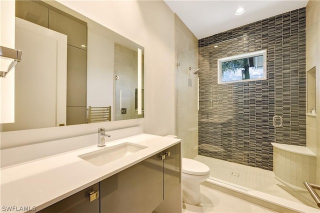 bathroom featuring vanity, toilet, and an enclosed shower