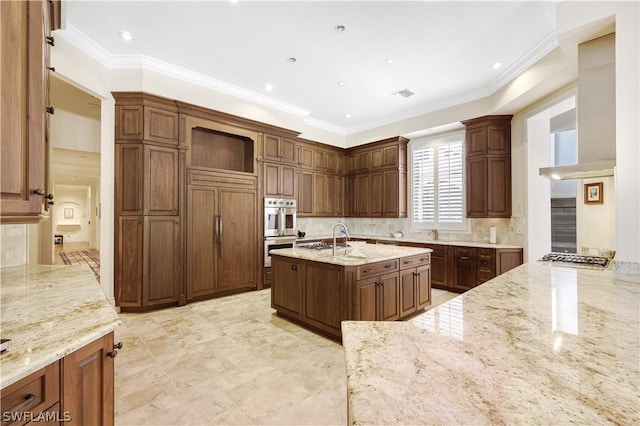 kitchen with crown molding, appliances with stainless steel finishes, light stone counters, and decorative backsplash