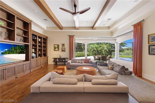 living room with beam ceiling, hardwood / wood-style floors, and ceiling fan