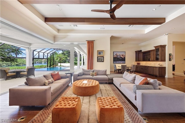 living room with ceiling fan, dark wood-type flooring, and beam ceiling