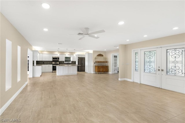 unfurnished living room featuring baseboards, french doors, a ceiling fan, and recessed lighting