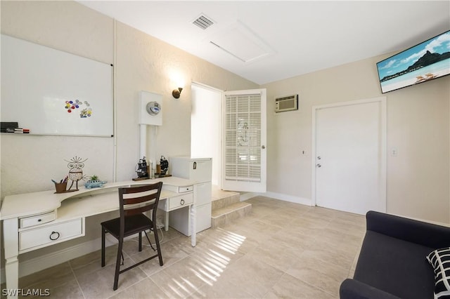 office area featuring visible vents and an AC wall unit