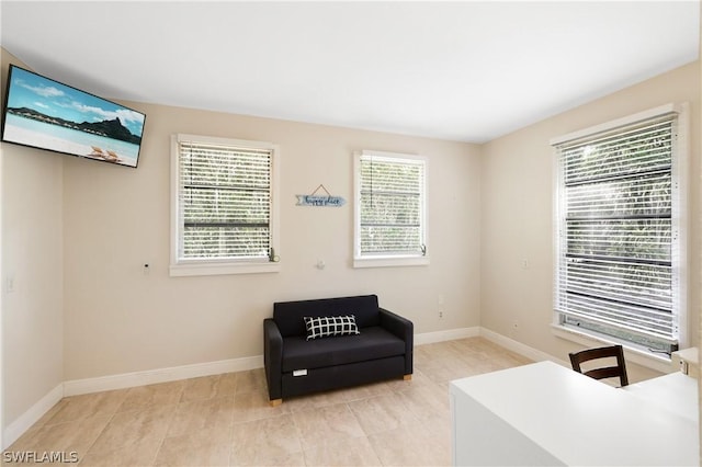 sitting room with baseboards and light tile patterned floors