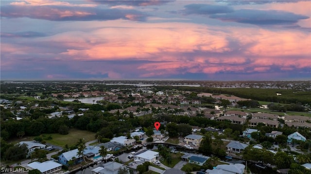 aerial view at dusk featuring a residential view