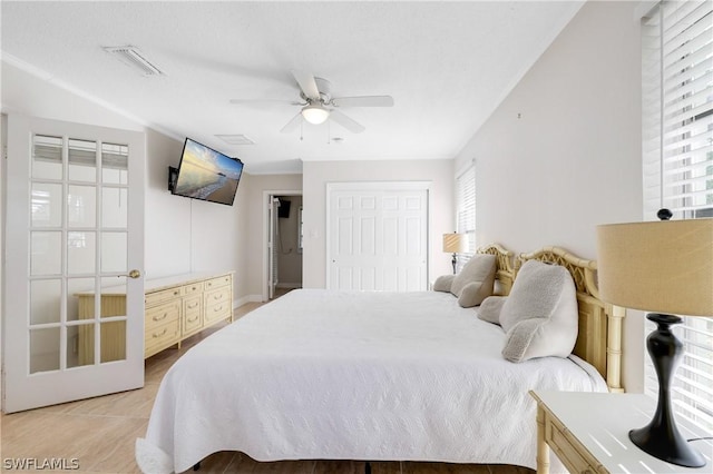 bedroom featuring light tile patterned floors, a closet, visible vents, and a ceiling fan