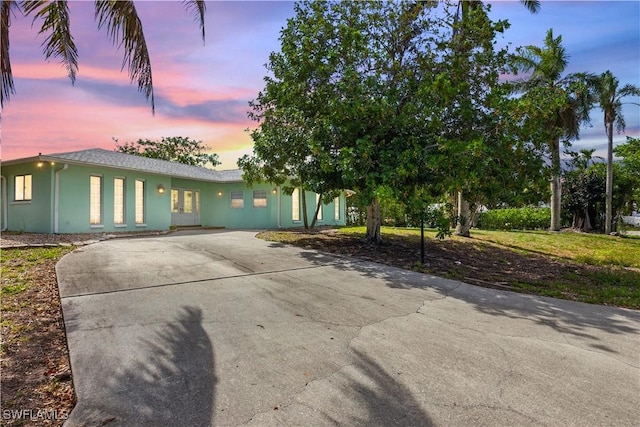 3461 Lakeview Dr, Naples, FL 34112 - view of front of home with driveway and stucco siding