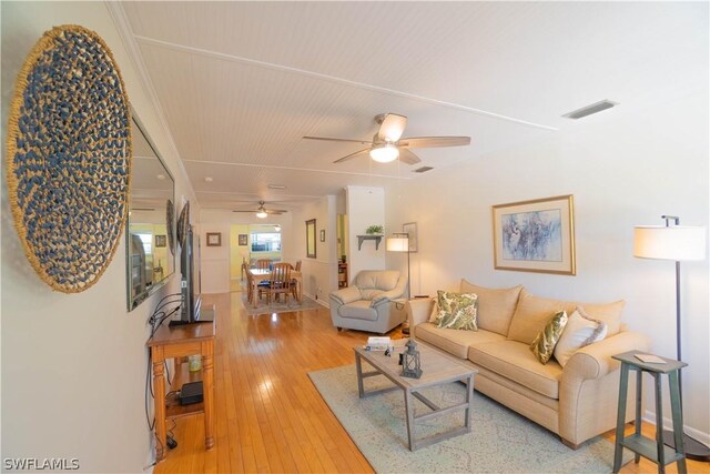 living room featuring ceiling fan and wood-type flooring