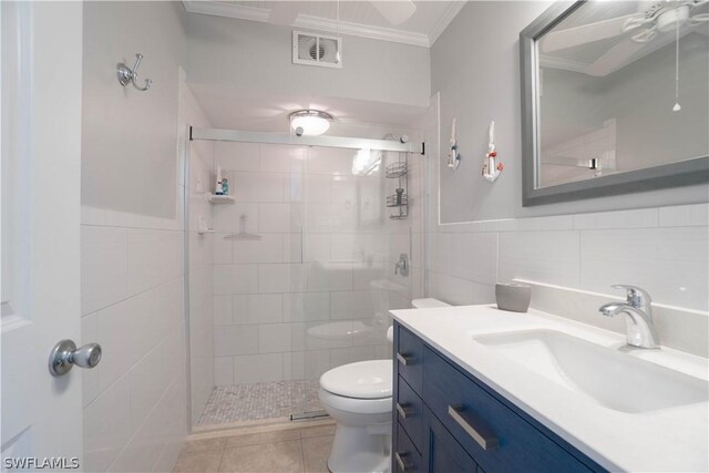 bathroom featuring tile patterned flooring, toilet, tile walls, vanity, and crown molding