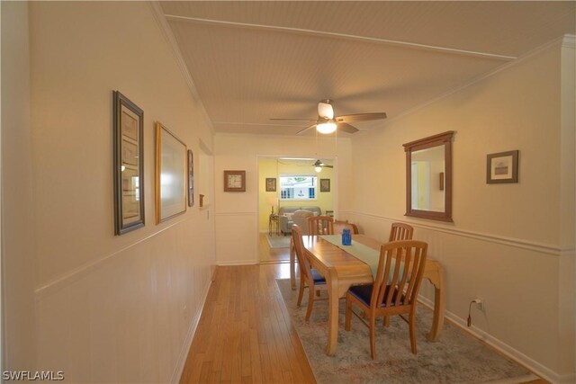 dining area with ceiling fan, light hardwood / wood-style flooring, and ornamental molding