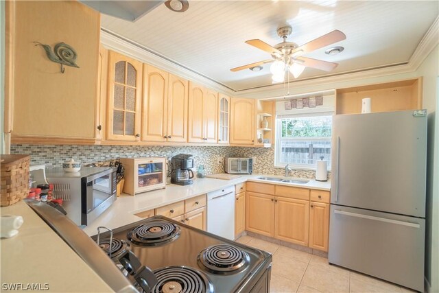 kitchen featuring sink, light brown cabinets, stainless steel appliances, and light tile patterned flooring