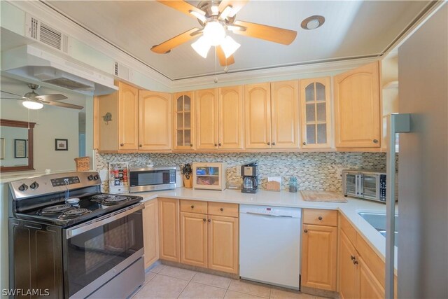 kitchen featuring appliances with stainless steel finishes, light brown cabinets, and tasteful backsplash