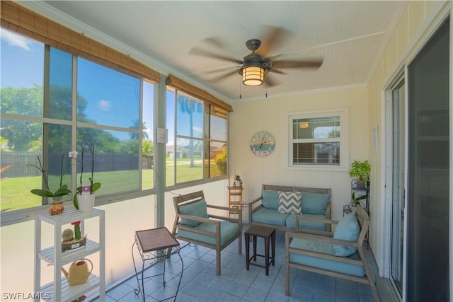 sunroom / solarium featuring ceiling fan