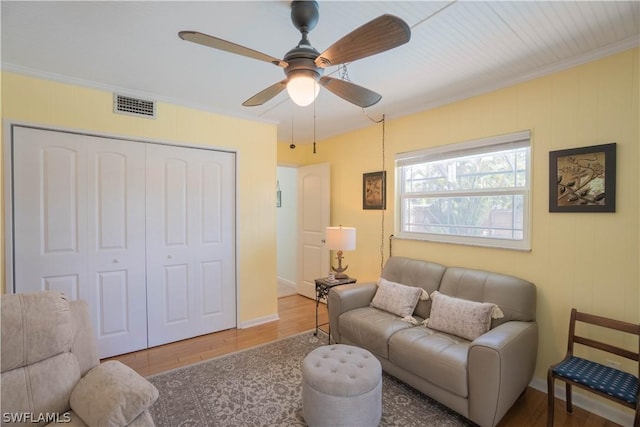 living room with ceiling fan, hardwood / wood-style floors, and crown molding