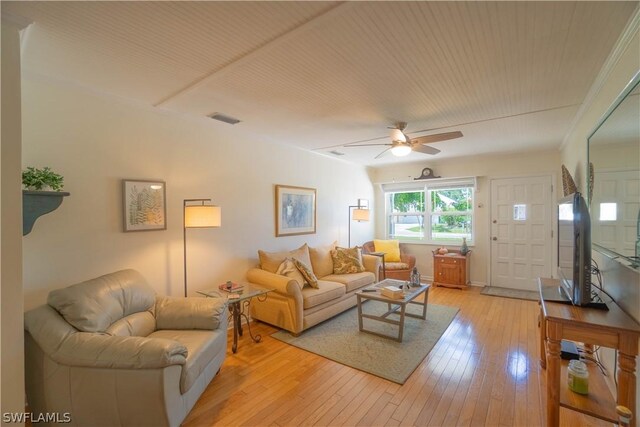 living room featuring light wood-type flooring and ceiling fan