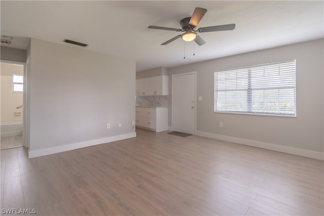 empty room featuring ceiling fan and light hardwood / wood-style floors