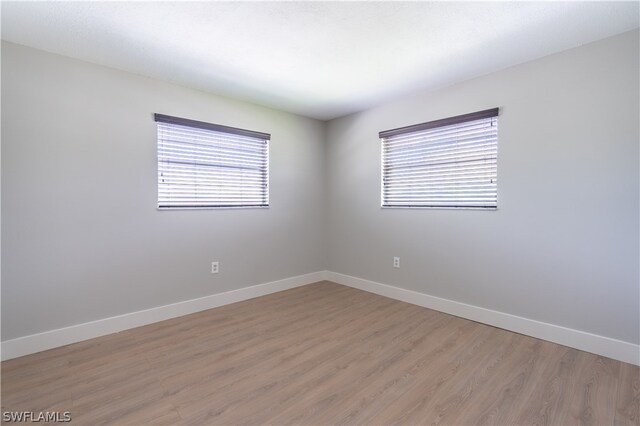 empty room with wood-type flooring