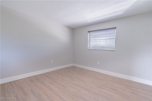 unfurnished room with light hardwood / wood-style floors