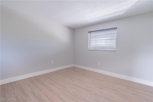 3325 Airport Rd N Unit S8, Naples, FL 34105 - spare room featuring light wood finished floors and baseboards