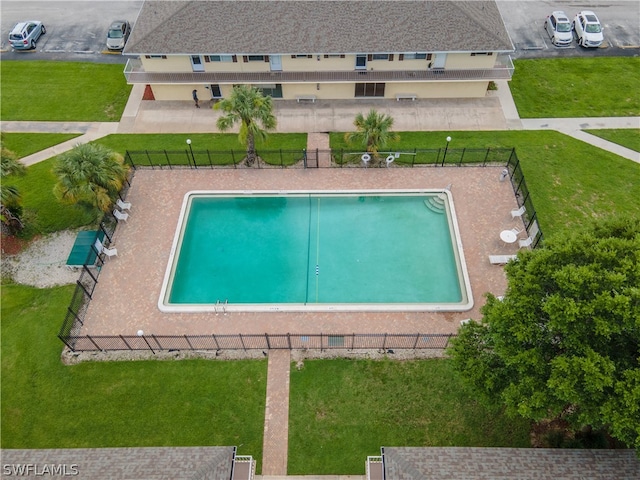 view of swimming pool with a patio and a yard