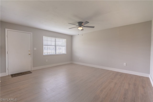 spare room with light hardwood / wood-style flooring and ceiling fan