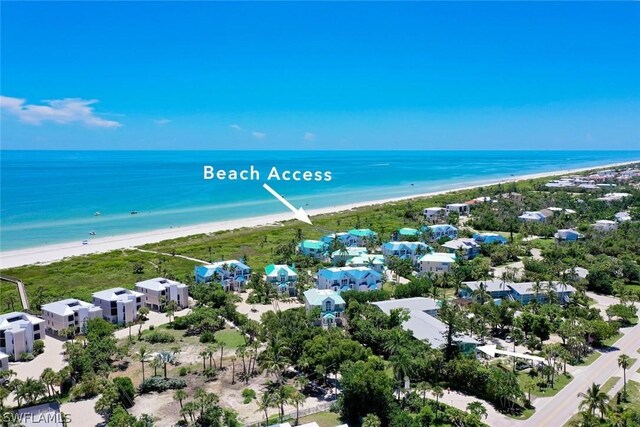 birds eye view of property featuring a view of the beach and a water view