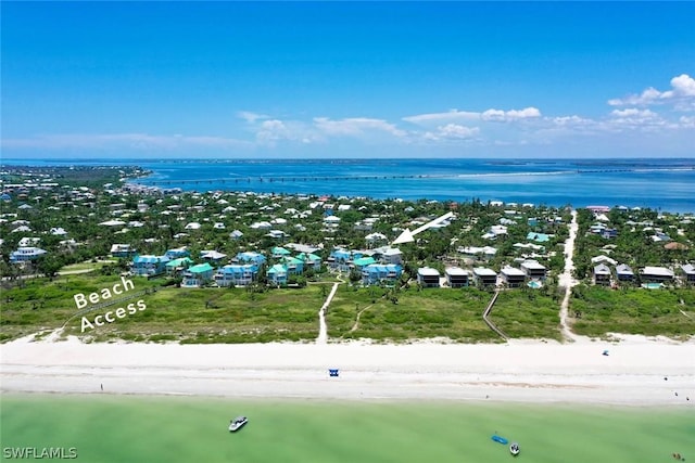 bird's eye view featuring a water view and a beach view