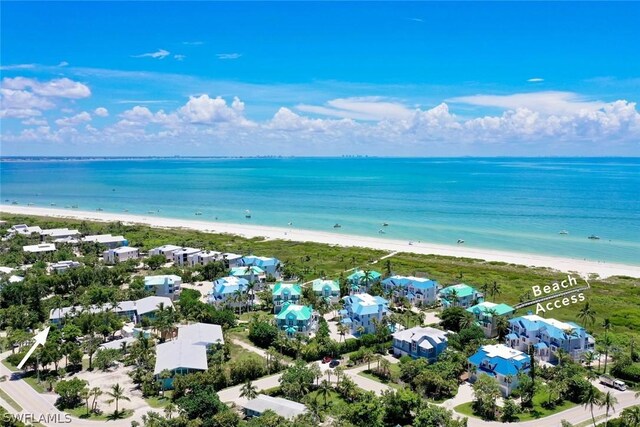 drone / aerial view featuring a water view and a view of the beach