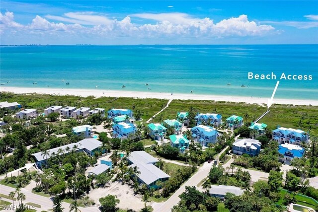 bird's eye view with a water view and a beach view