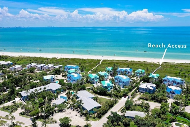 birds eye view of property with a view of the beach and a water view