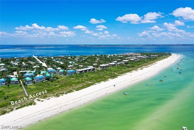 bird's eye view with a water view and a beach view