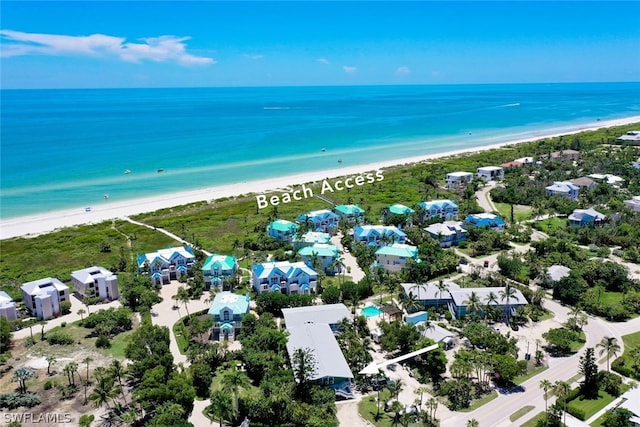 drone / aerial view featuring a water view and a view of the beach