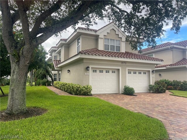 view of front of property with a garage and a front lawn