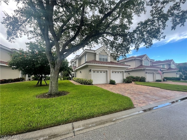 view of front of property with a garage and a front yard