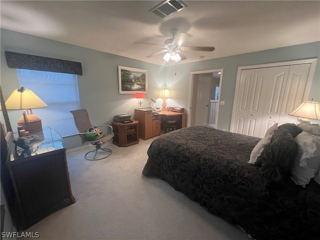 carpeted bedroom featuring ceiling fan and a closet