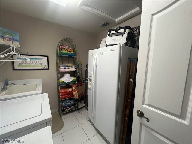 clothes washing area with light tile patterned floors and sink