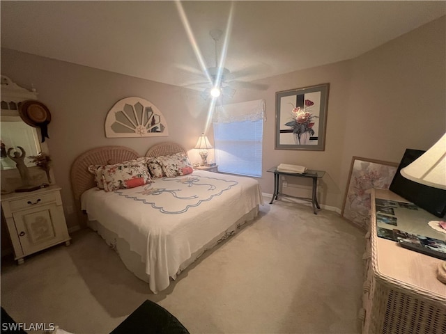 bedroom featuring light carpet and ceiling fan