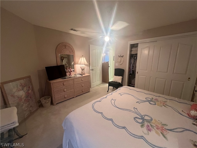 bedroom with light carpet and a closet