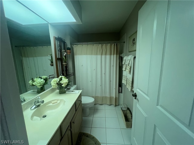 bathroom featuring vanity, tile patterned flooring, and toilet